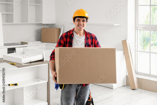 Male worker with cardboard ...