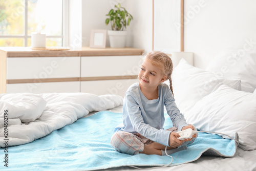 Cute little girl turning on...