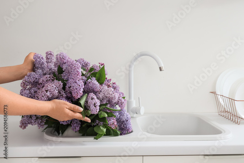 Female hands and sink with ...