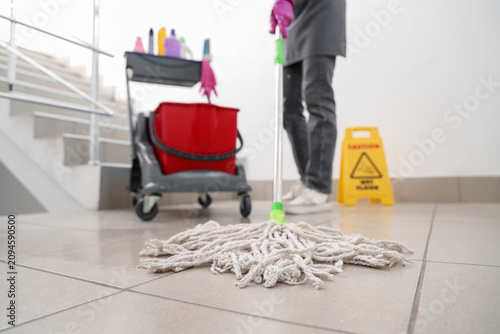 Female janitor with trolley...