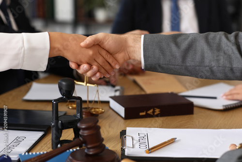Lawyers shaking hands at ta...