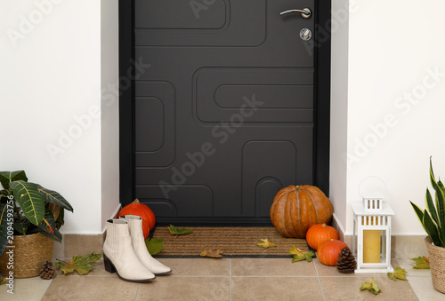Black door with pumpkins, a...