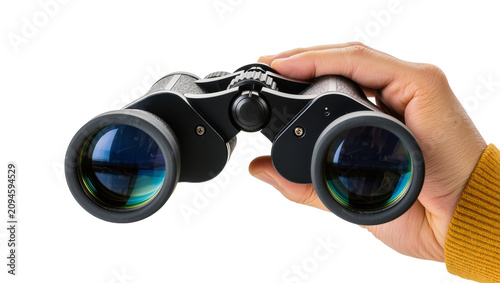 Isolated close-up of a human hand holding black and silver binoculars for observation or exploration