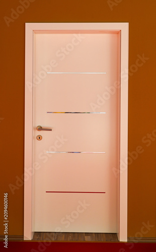 Closed wood white door inside corridor interior