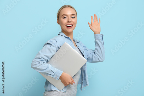 Happy young woman with lapt...