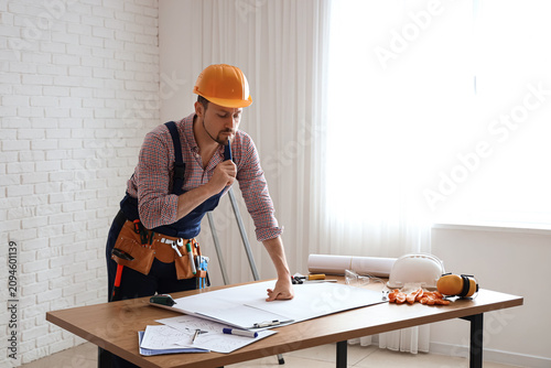 Thoughtful male builder wor...