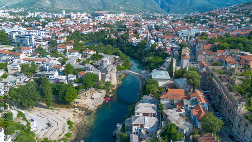 Quadro su tela Top down aerial drone view of the historic Stari Most Mostar Old Bridge over Ner