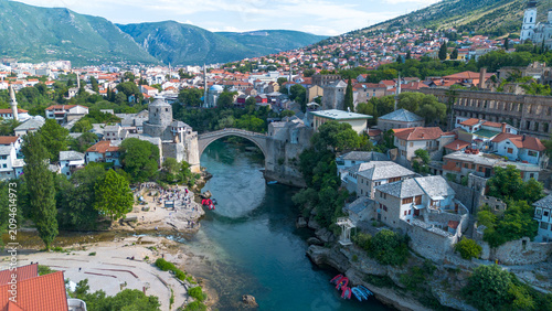 Top down aerial drone view of the historic Stari Most Mostar Old Bridge over Neretva river in Bosnia and Herzegovina
