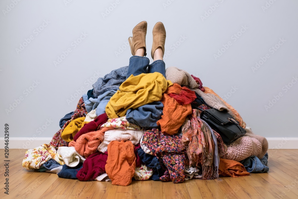 Obraz premium The Pile of Clothes with Boots Propped Up in Cozy Home Laundry Chaos