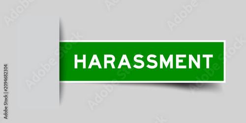 Green color square shape sticker label with word harassment inserted in gray background