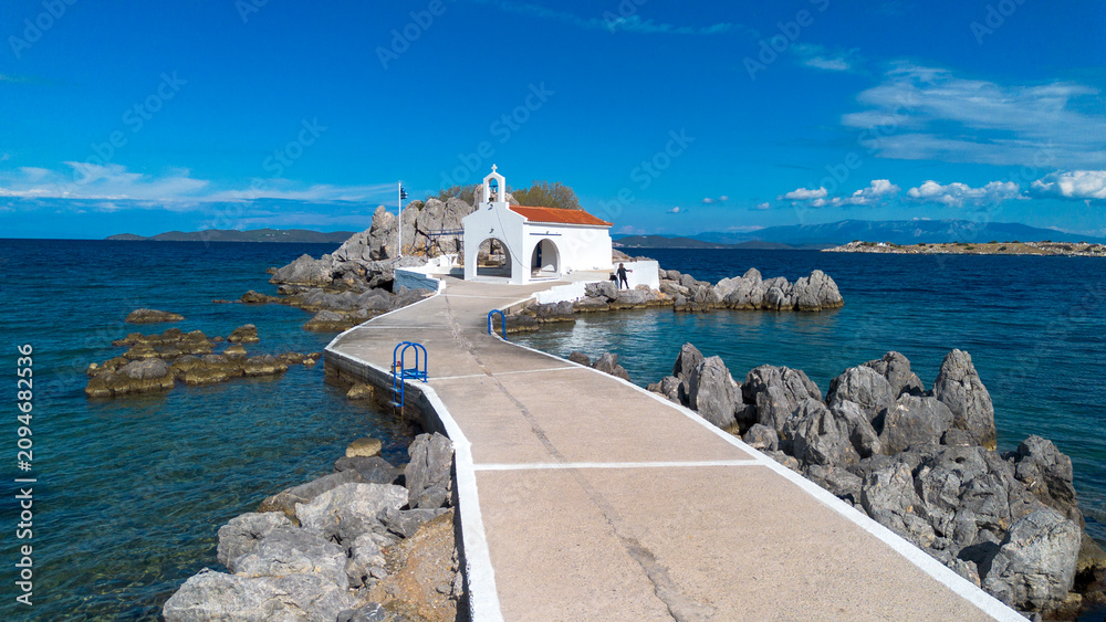 Fototapeta premium Aerial view of the chapel of Agios Isidoros on a rocky islet in Chios island Greece