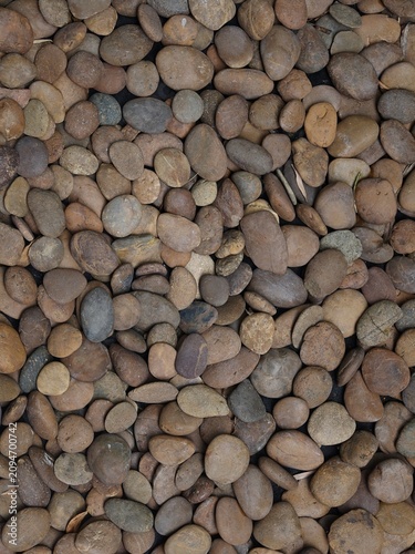 Smooth Brown River Pebbles Background Texture Viewed from Above
