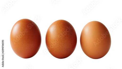 Isolated three brown hen eggs arranged in a line, fresh farm produce for cooking ingredients