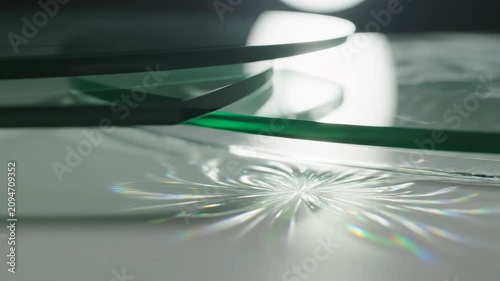 Light reflection on clear glass with circular patterns and shadows during a bright moment