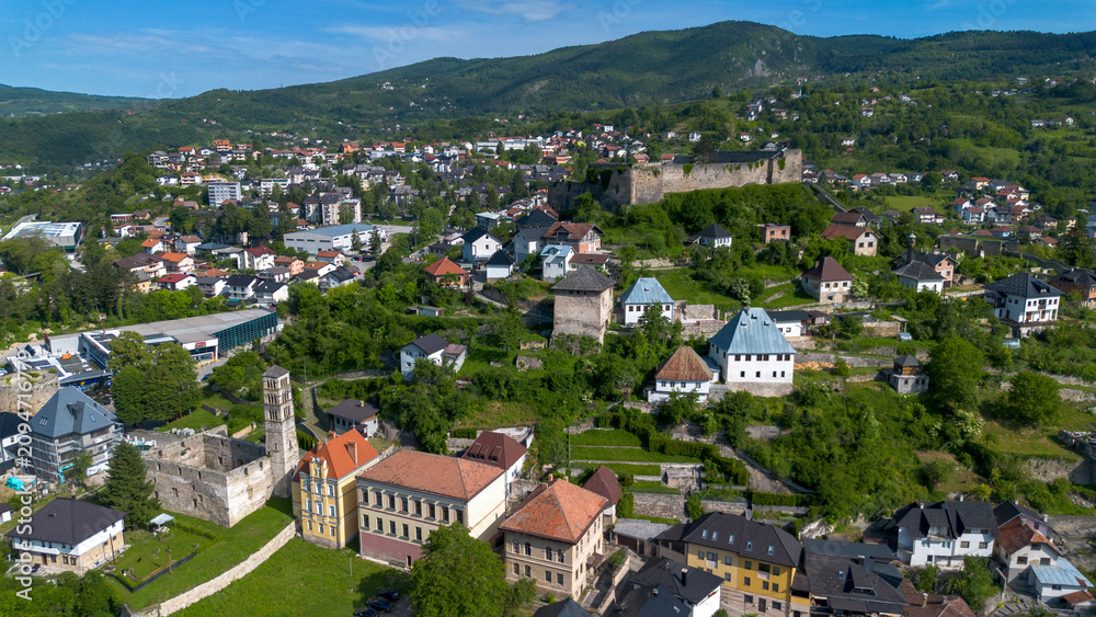 Fototapeta premium Drone view of St Luke belfry with ruined church and Jajce fortress on the hill
