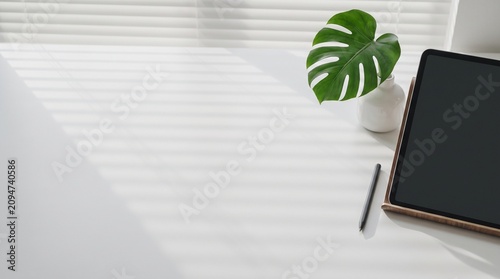 Creative workspace with digital tablet on a white desk 1