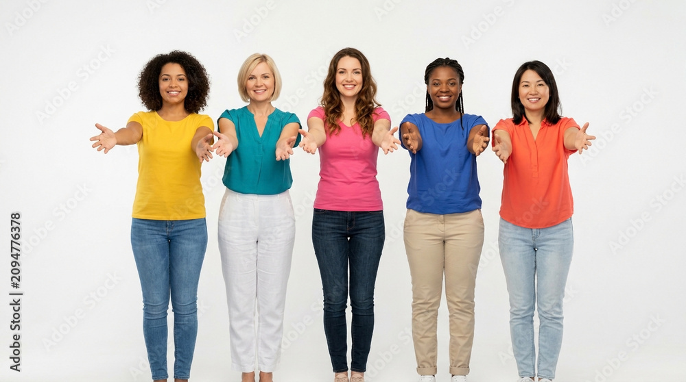 Fototapeta premium Five diverse women in colorful casual shirts stand side by side holding their hands forward together