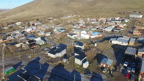 4K aerial drone footage flying over 28 de Noviembre, a Patagonian town in Santa Cruz, Argentina. Scenic mountain surroundings, residential neighborhoods, and the unique landscape of southern Patagonia