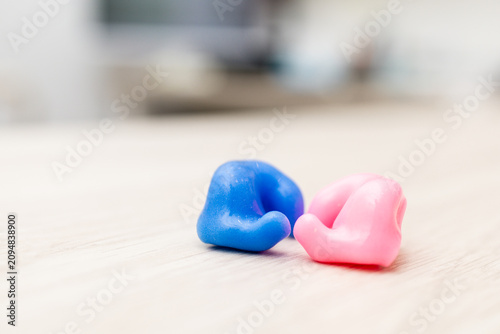Принти на полотні Photo of custom-made two-tone earplugs on a wooden surface.