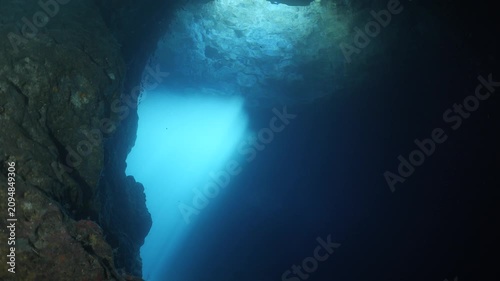 sun rays sun beams and sun shine underwater in cave beautiful light scenery in ocean scuba divers to see in cave backgrounds
