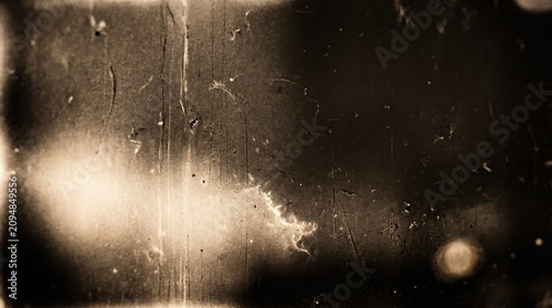 Vintage film grain texture background, old movie effect, scratched surface, sepia tone, retro aesthetic, grunge overlay, noise pattern, cinematic atmosphere, aged paper look