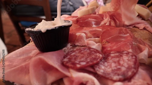 Italian charcuterie board with prosciutto and Squacquerone cheese celebrating traditional Italian cuisine. Tagliere di salumi.