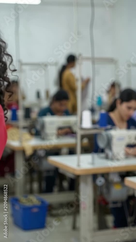 Female workers operating sewing machines in a garment factory 