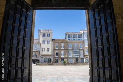 CELANOVA, SPAIN - JULY 6, 2025: Traditional residential buildings with white glass galleries at Praza Maior in Celanova, Ourense, Galicia.