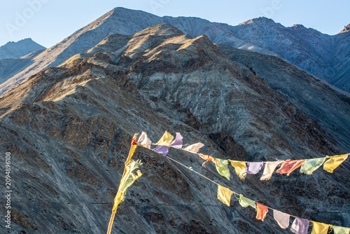 Konstfotografi Frayed Tibetan prayer flags in front of the mountains in Ladakh, India