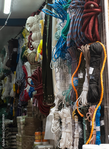Obraz na płótnie Colorful braided ropes and utility cords on spools in hardware store