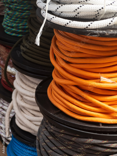 Obraz na plátně Colorful braided ropes and utility cords on spools in hardware store