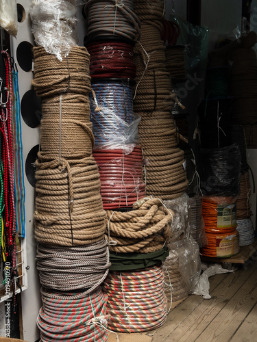 Photos Colorful braided ropes and utility cords on spools in hardware store