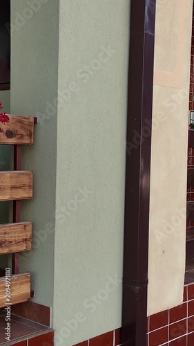 Beautiful balcony with blooming geraniums and wooden railing