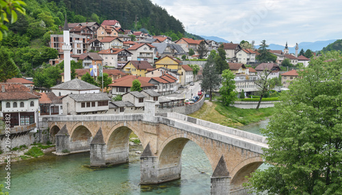 Historic Stone Bridge Over Emerald Neretva River in Scenic Konjic Townscape, Bosnia and Herzegovina