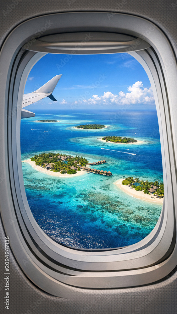 Fototapeta premium Breathtaking aerial view of tropical island chain from airplane window.