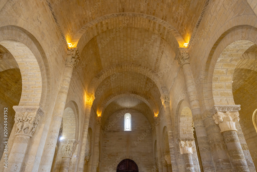 Fototapeta premium Romanesque church interior showing arches and stone vaults