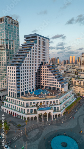 Photography aerial close up view of isrotel tower skyscraper and london square at sunset in