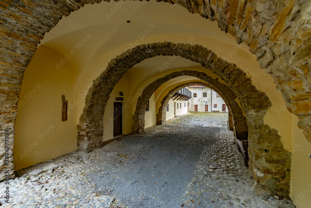 Fototapeta premium Archway tunnel leading to courtyard at Cerveny Klastor, Slovakia