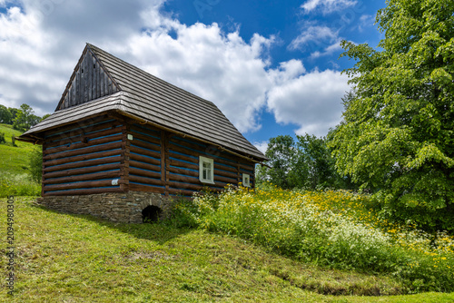 Tableau sur toile Traditional wooden log house in Osturna village, Slovakia