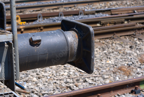 Schilderij op canvas Close-up buffer of parked railway freight wagon at train station of Swiss village of Rümlang on a sunny hot summer day