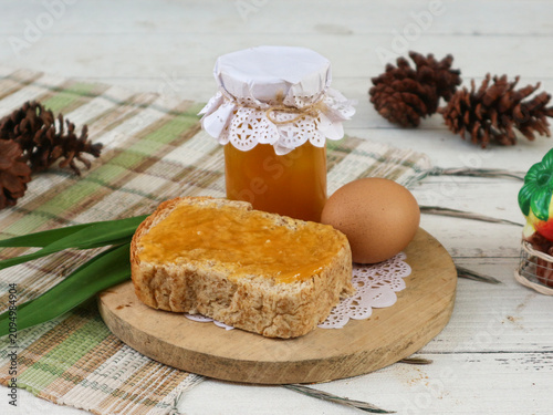 Fotografie A bottle of rich, sweet kaya, also known as srikaya jam, paired with a slice of toast