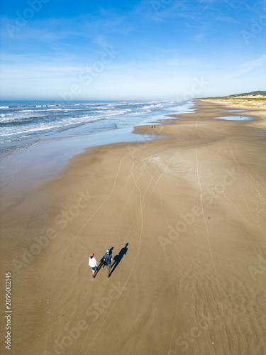 Couple Hiking Along the Beach with Panoramic Coastal View in Torres, Brazil