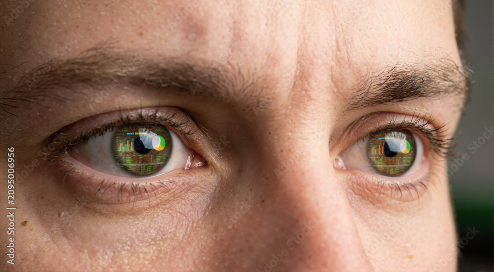 Naklejka premium Macro close up of human eyes with reflection of financial charts. Intense focus of trader analyzing data on betting exchange screen