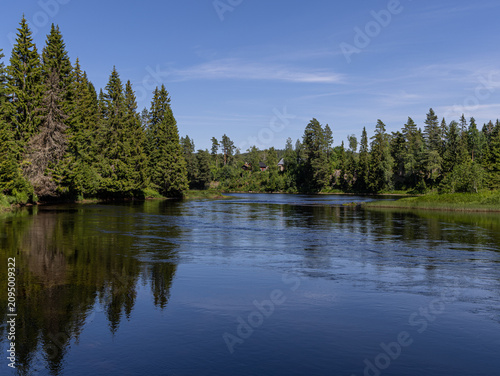Calm Reflections on Västerdalälven River in Sweden, Summer