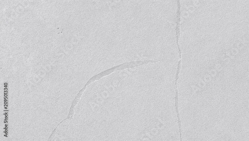 Concrete Surface With Cracks and Textures Visible in a Gray Color