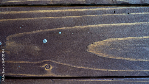 Фотография Aged dark wooden boards with visible grain and nail heads