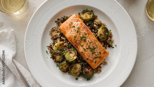 Delicious Salmon With Roasted Brussels Sprouts and Barley Served on a White P...