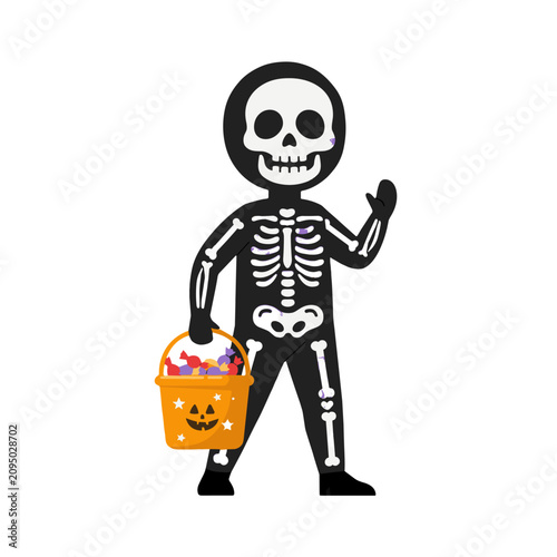 A child dressed in a skeleton costume for Halloween, holding a pumpkin bucket full of candy.