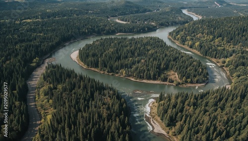 Winding River Flows Through Green Forest Landscape Under Bright Sky in the Da...