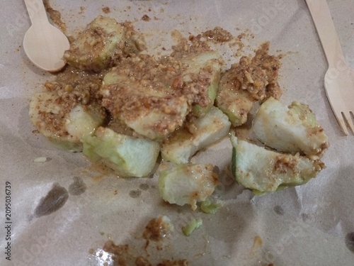 Chicken satay, rice cake and peanut sauce wrapped in brown paper and banana leaves. Semarang, 12-07-2026